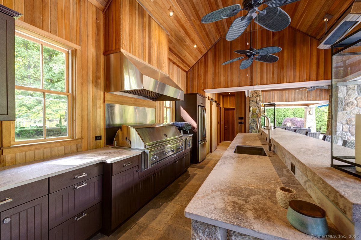 174 Branchville Road Ridgefield, CT 06877 - Photo 34 of 40 a kitchen with sink refrigerator and large window