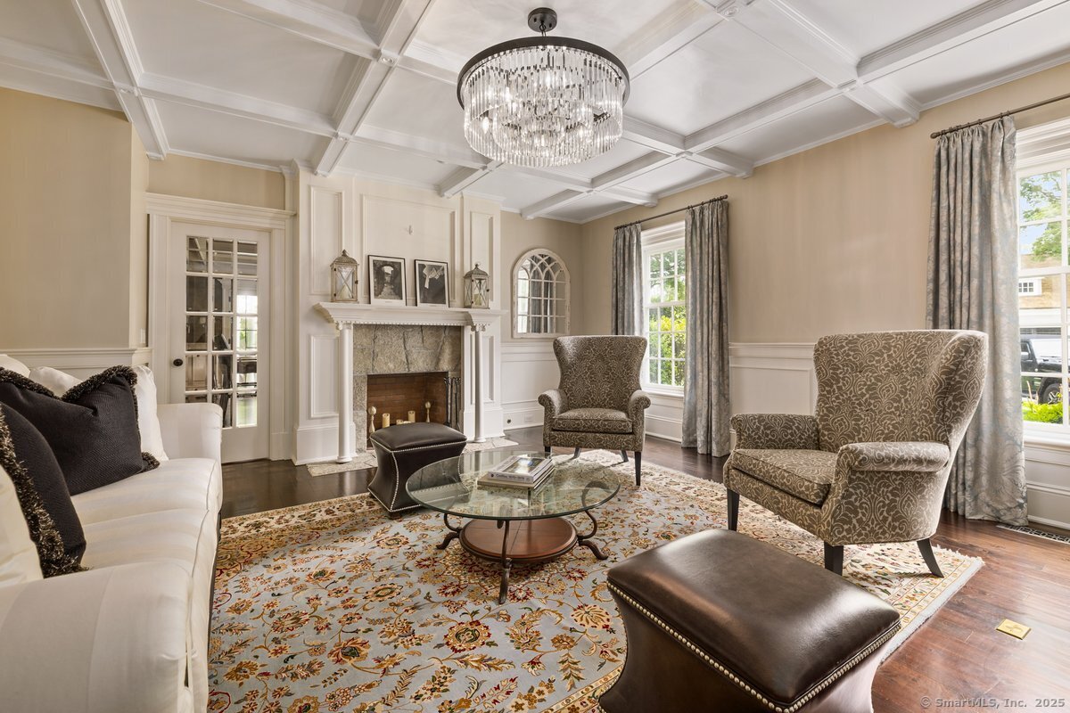 174 Branchville Road Ridgefield, CT 06877 - Photo 4 of 40 a living room with furniture a fireplace and a chandelier