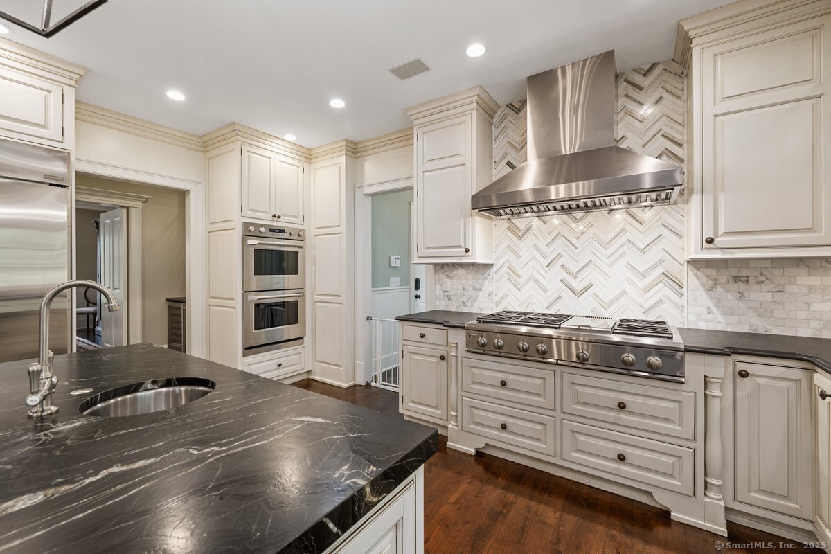 174 Branchville Road Ridgefield, CT 06877 - Photo 9 of 40 a kitchen with stainless steel appliances granite countertop a stove a sink and a refrigerator