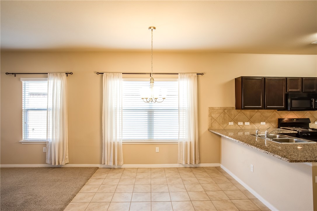 607 Brashear Lane Cedar Park, TX 78613 - Photo 14 of 28 a kitchen with stainless steel appliances granite countertop a sink and a stove top oven