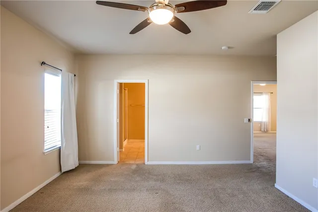 an empty room with closet and window