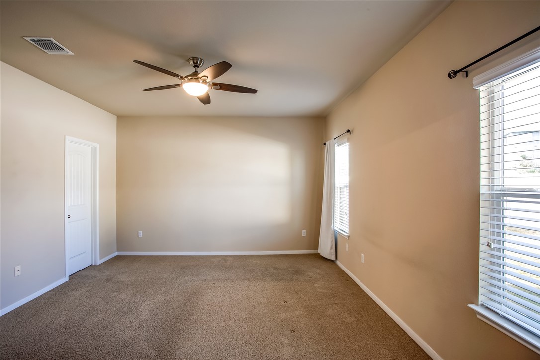 607 Brashear Lane Cedar Park, TX 78613 - Photo 18 of 28 wooden floor in an empty room with a window