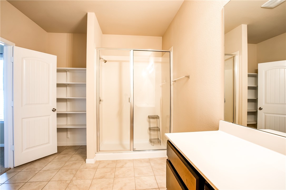 607 Brashear Lane Cedar Park, TX 78613 - Photo 20 of 28 a bedroom with a bed and a refrigerator