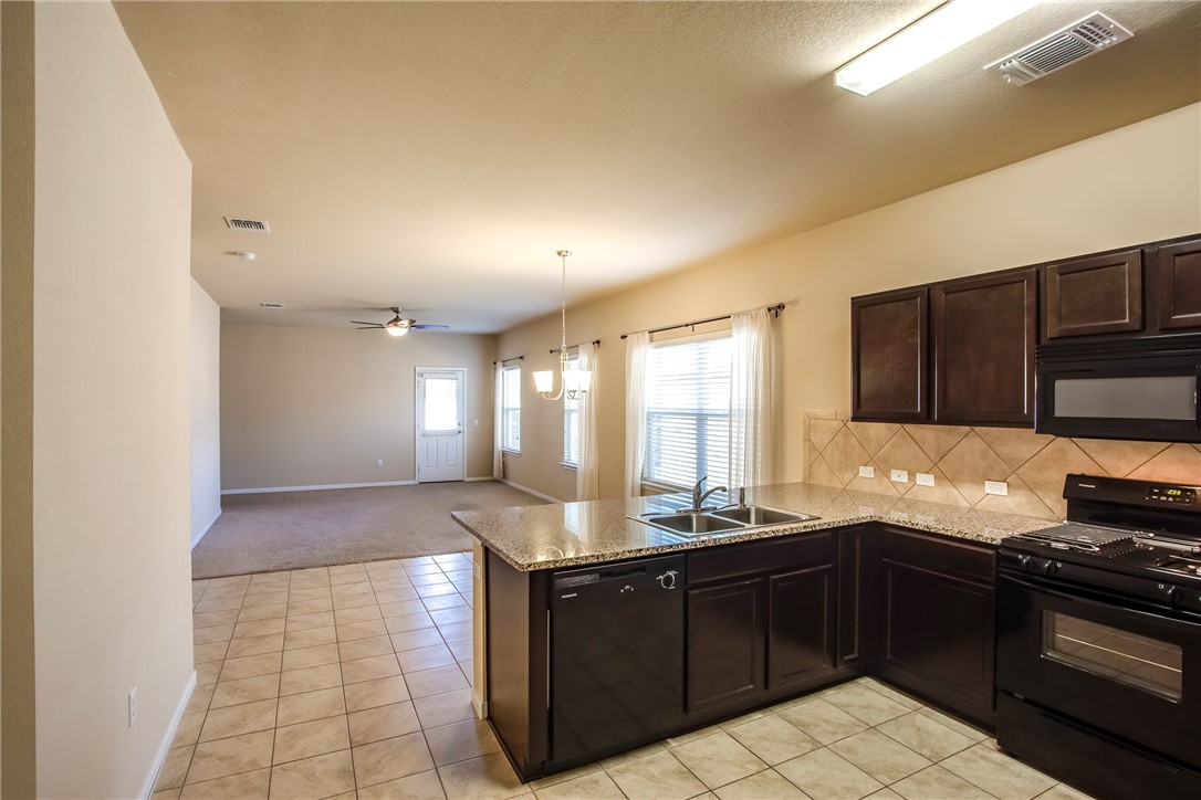 607 Brashear Lane Cedar Park, TX 78613 - Photo 5 of 28 a kitchen with stainless steel appliances granite countertop a sink stove and refrigerator