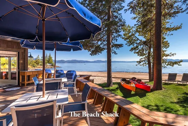a view of a patio with a table and chairs under an umbrella