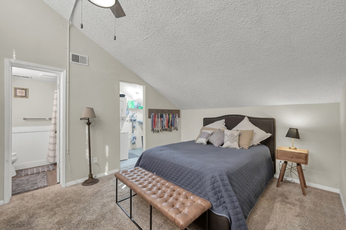 12900 Walden Road, Unit 620 Montgomery, TX 77356 - Photo 12 of 21 a bedroom with a bed and a chandelier