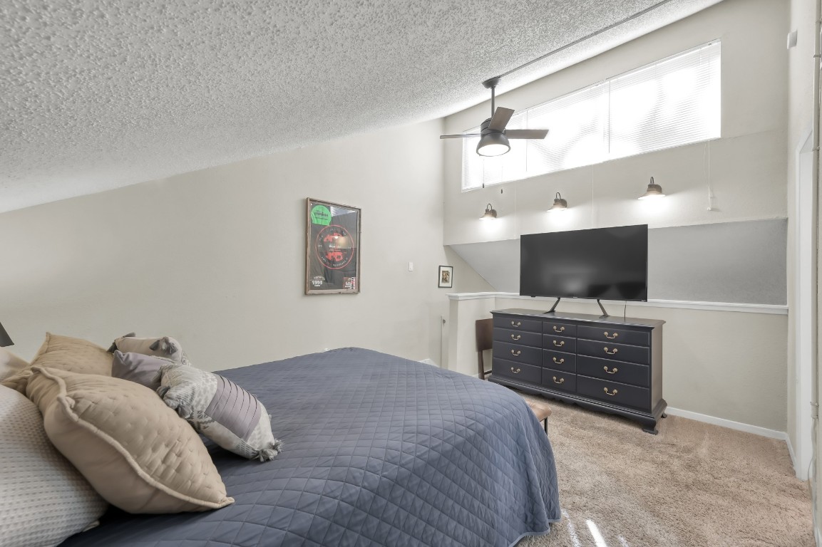 12900 Walden Road, Unit 620 Montgomery, TX 77356 - Photo 13 of 21 a bedroom with furniture and a flat screen tv