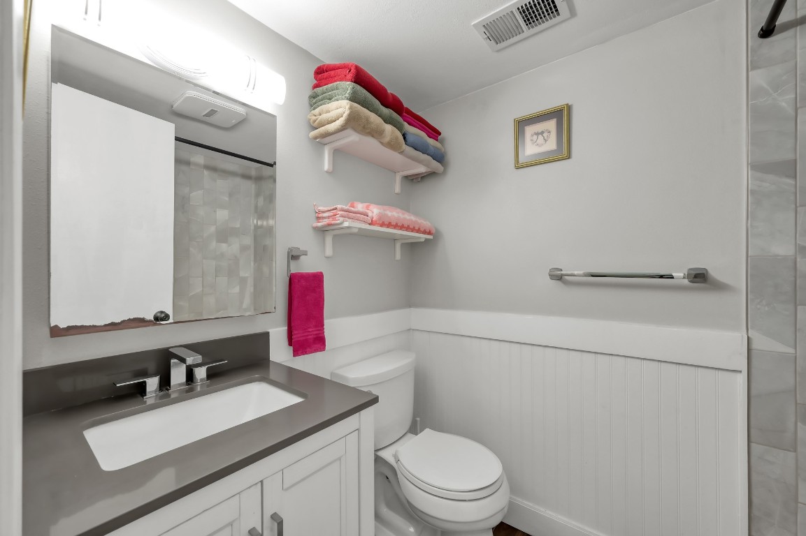 12900 Walden Road, Unit 620 Montgomery, TX 77356 - Photo 14 of 21 a bathroom with a sink vanity mirror and toilet