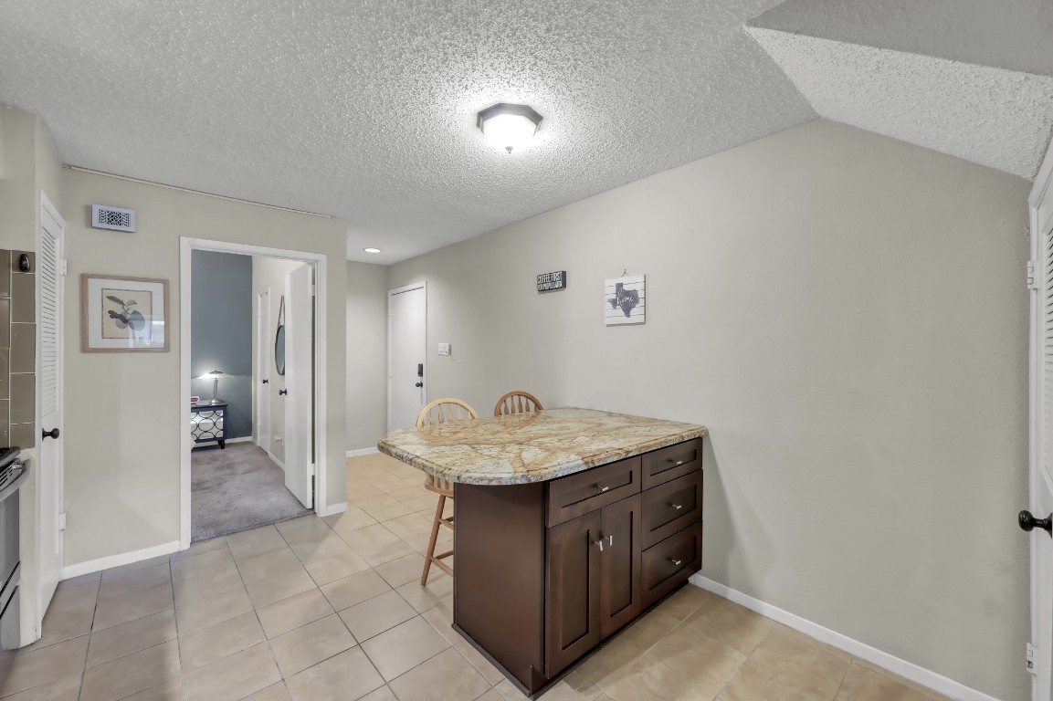 12900 Walden Road, Unit 620 Montgomery, TX 77356 - Photo 3 of 21 a bathroom with a granite countertop sink a mirror and a shower