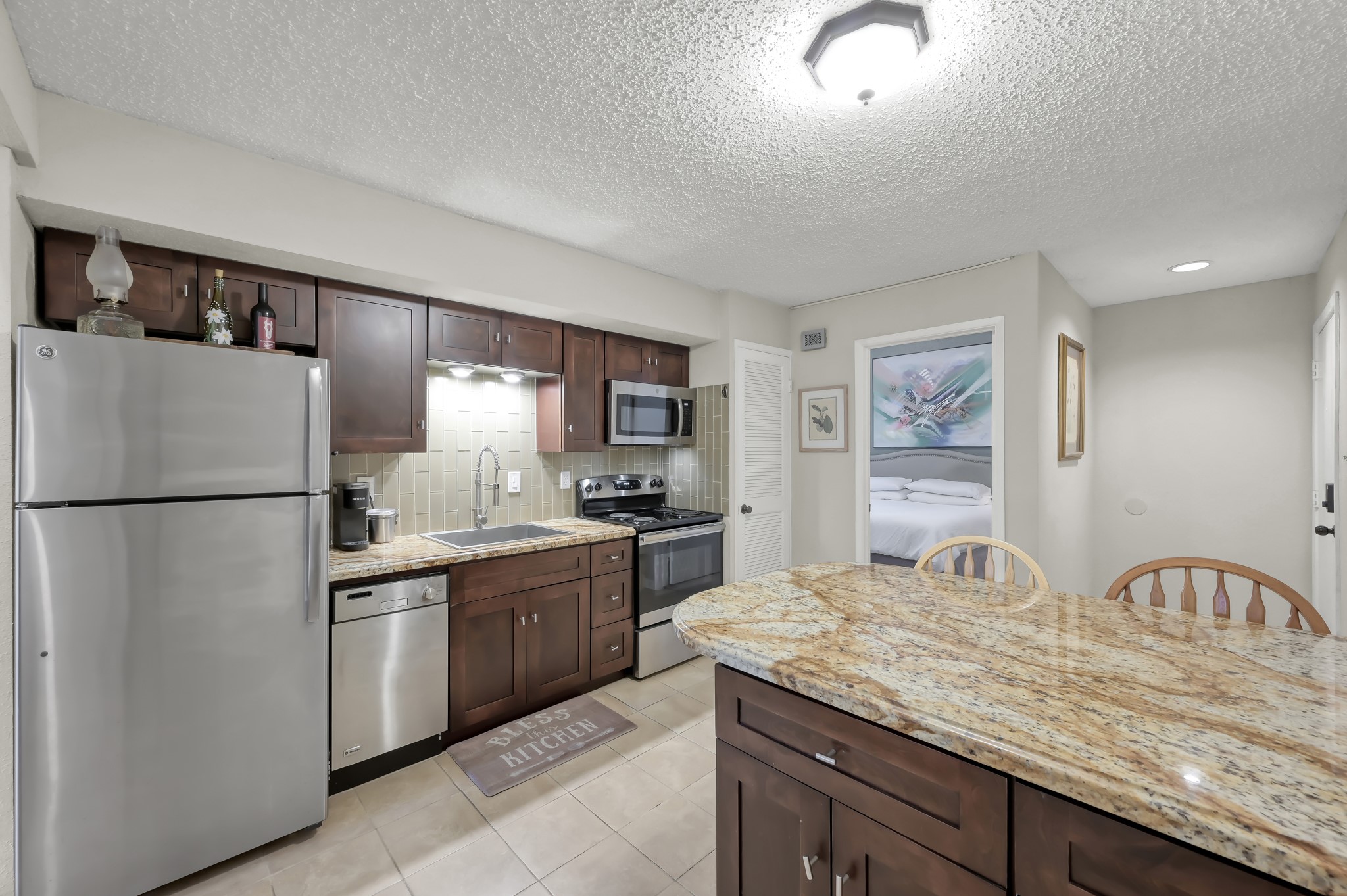12900 Walden Road, Unit 620 Montgomery, TX 77356 - Photo 4 of 21 a kitchen with granite countertop a sink stainless steel appliances and cabinets