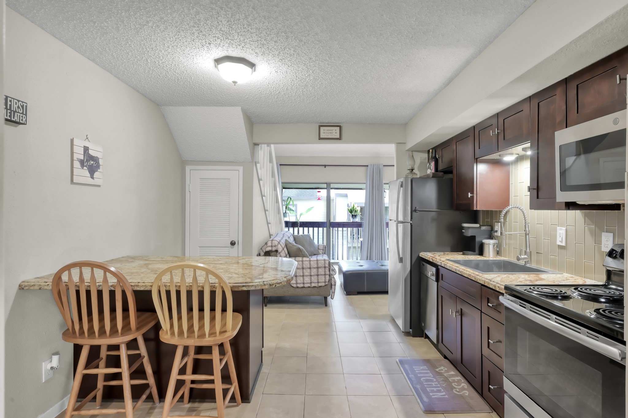 12900 Walden Road, Unit 620 Montgomery, TX 77356 - Photo 5 of 21 a kitchen with a dining table chairs and stainless steel appliances