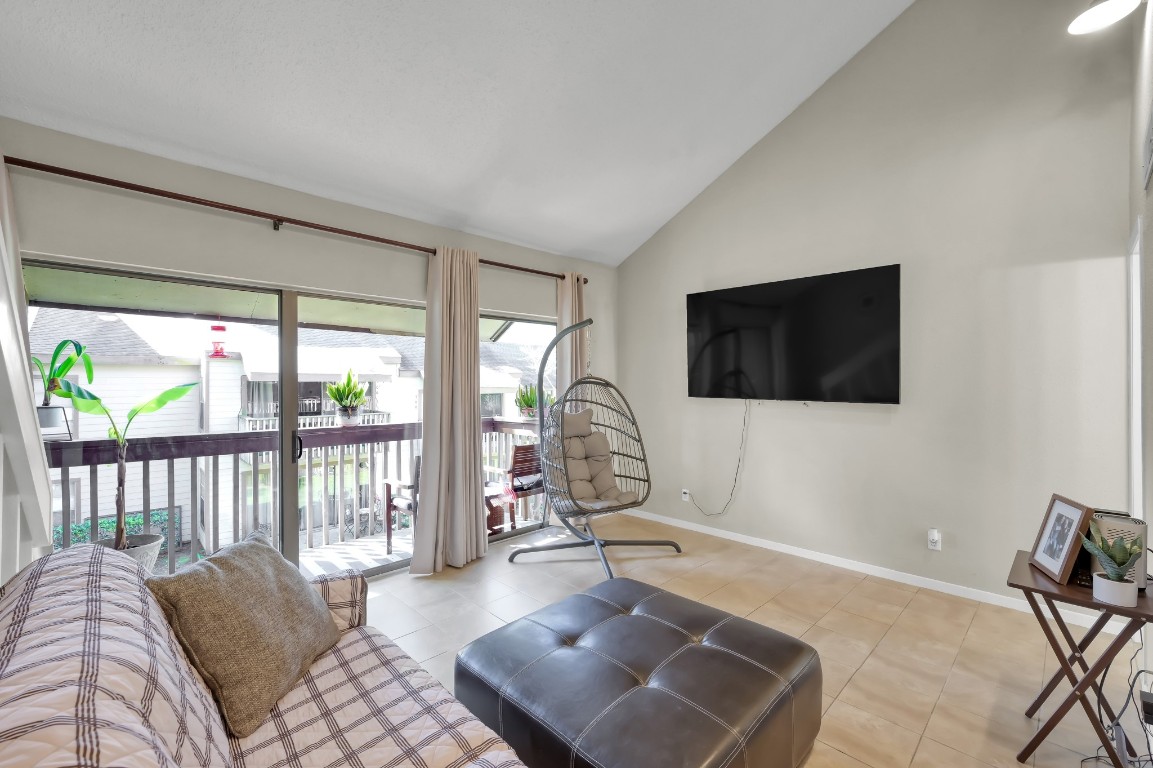 12900 Walden Road, Unit 620 Montgomery, TX 77356 - Photo 6 of 21 a living room with couches a coffee table and a flat screen tv