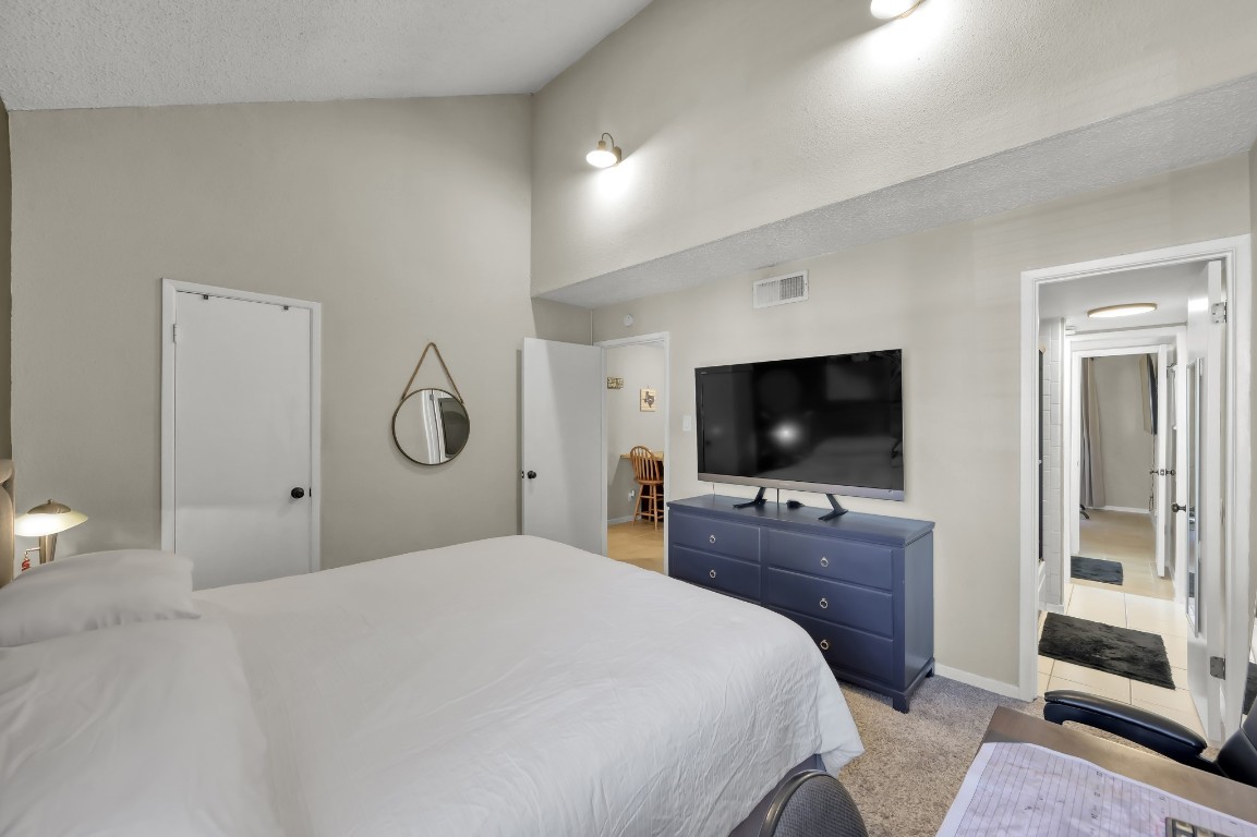 12900 Walden Road, Unit 620 Montgomery, TX 77356 - Photo 10 of 21 a bedroom with a bed and a flat screen tv