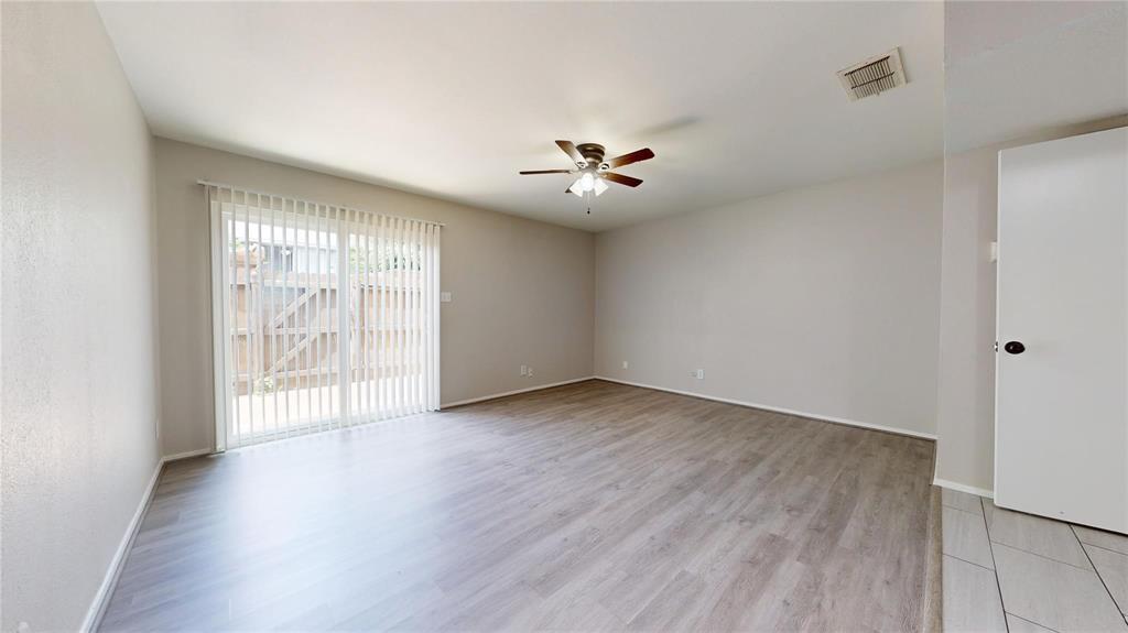 7700 Chapin Road, Unit 5 Fort Worth, TX 76116 - Photo 6 of 12 Expansive interior with wood-finish flooring, a ceiling fan, and light-toned walls