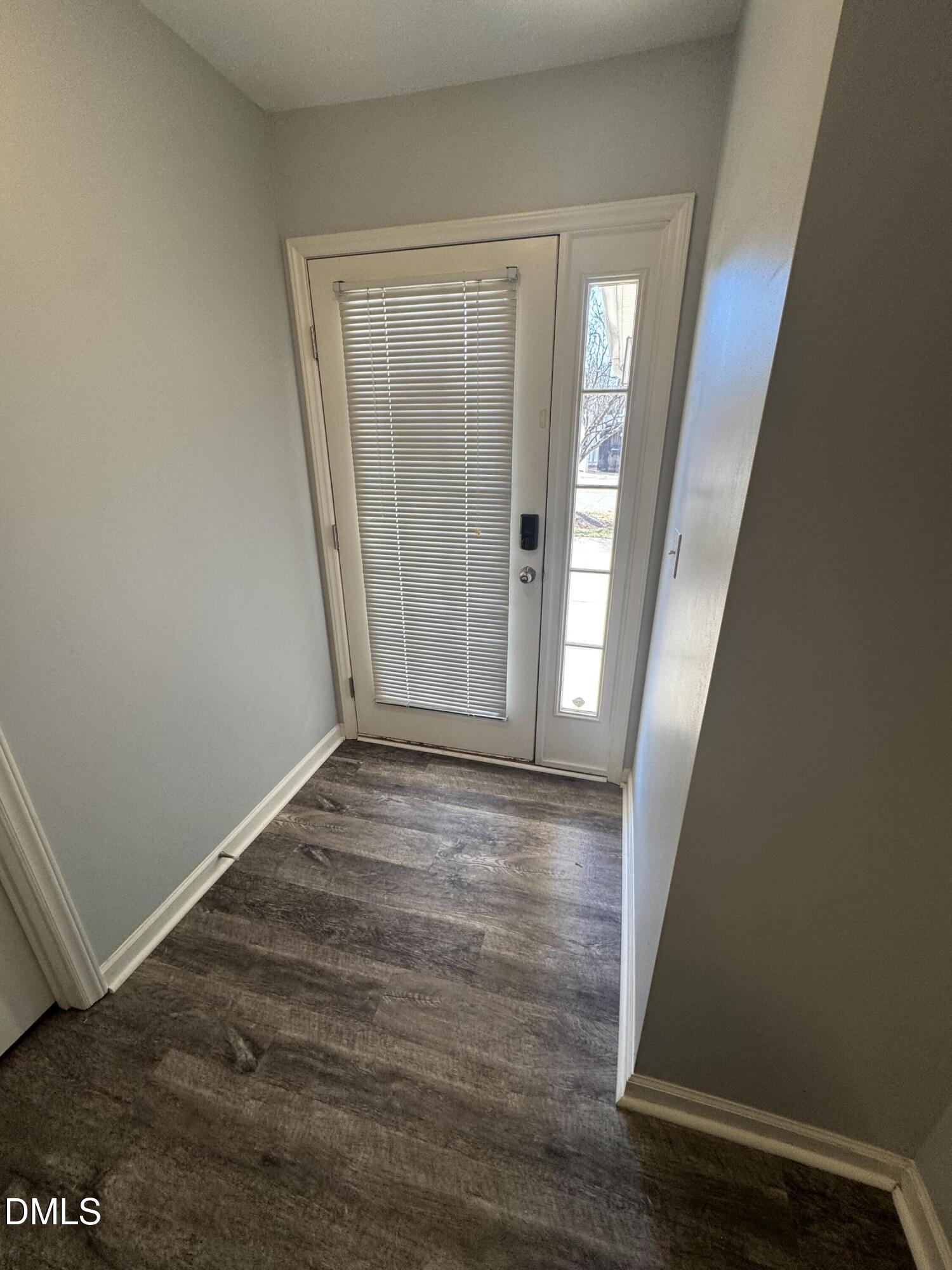 11351 Clubhaven Place, Unit 100 Raleigh, NC 27617 - Photo 5 of 29 an empty room with wooden floor and entrance