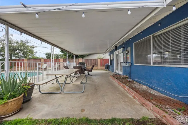 a view of a patio with table and chairs potted plants with wooden floor