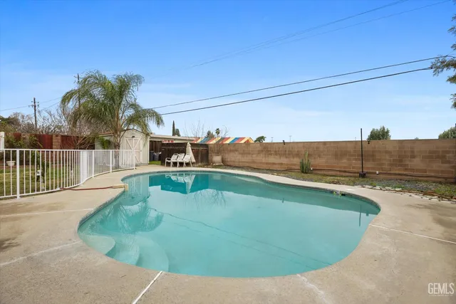 a view of a swimming pool with a lounge chair