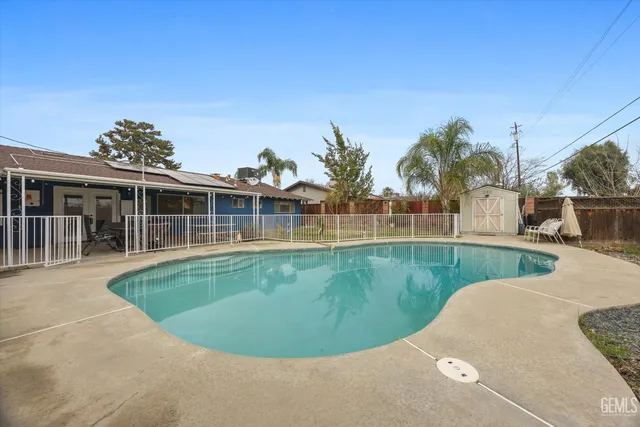 a view of a swimming pool with a backyard