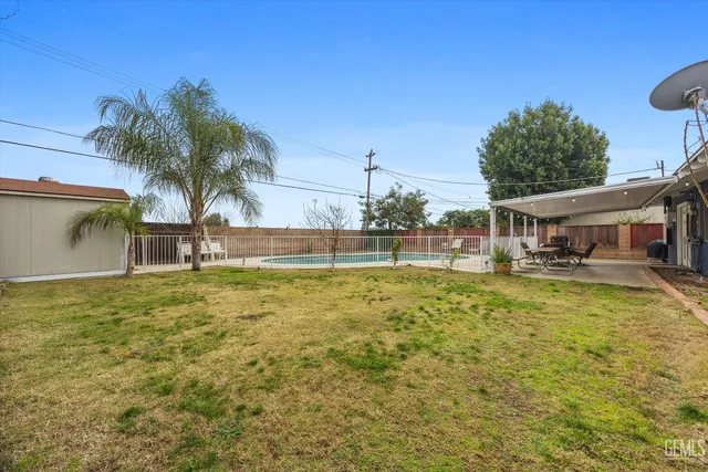 a view of a house with pool and chairs