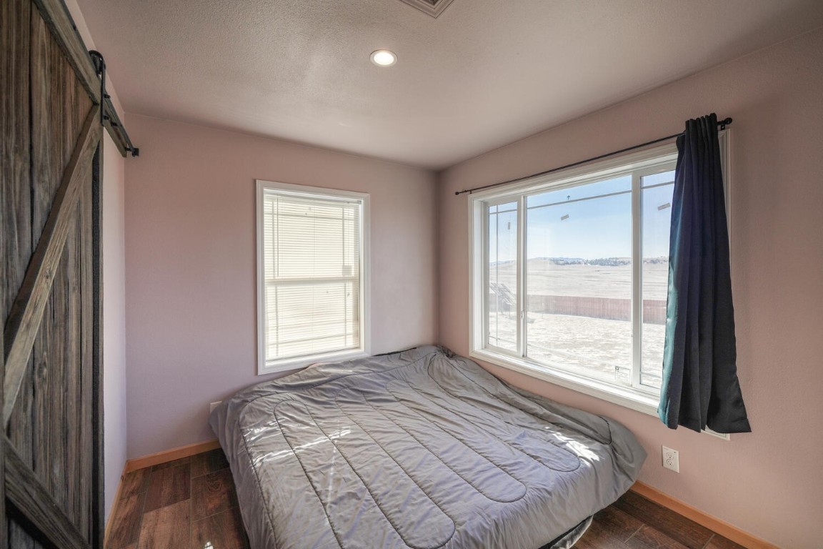 608 Rio Blanco Road Hartsel, CO 80449 - Photo 11 of 26 a bed sitting in a bedroom next to a window
