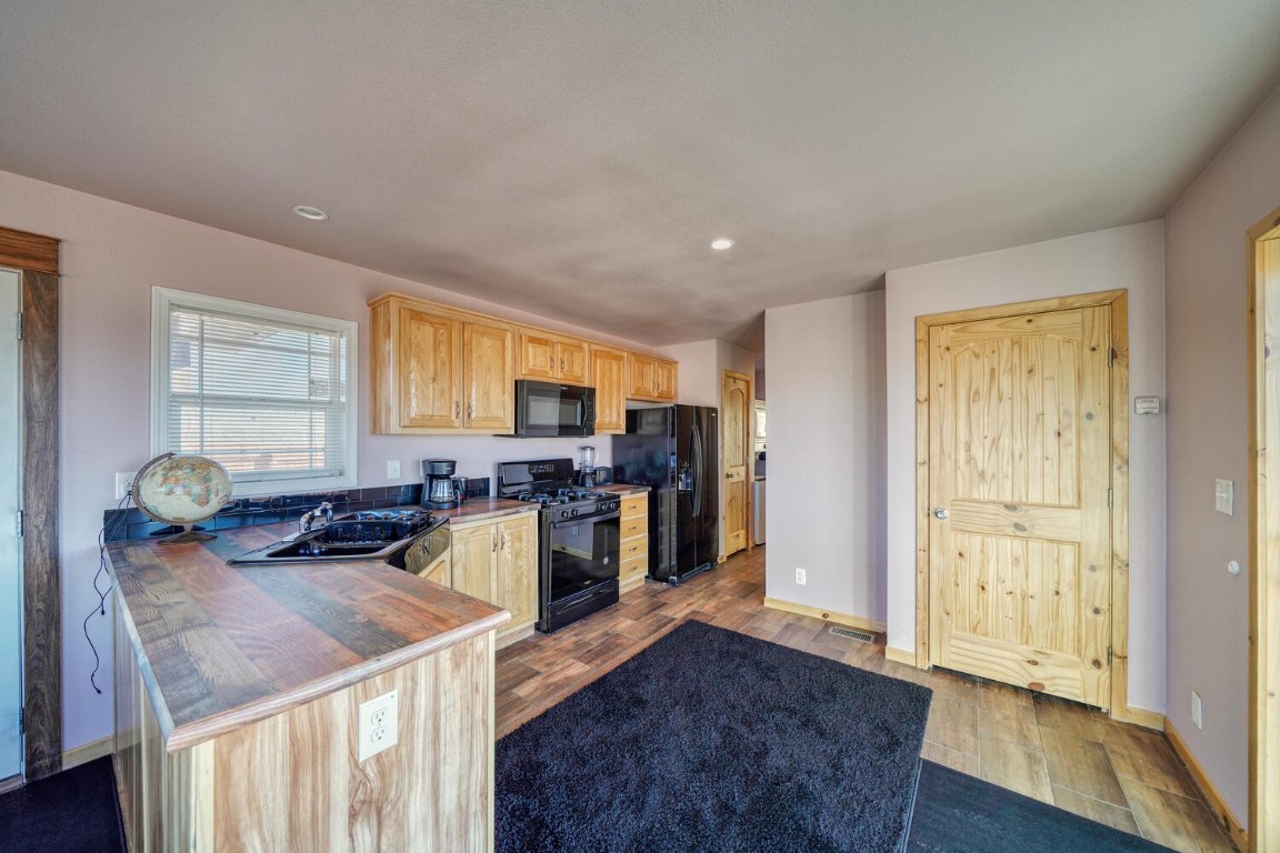 608 Rio Blanco Road Hartsel, CO 80449 - Photo 6 of 26 a kitchen with sink refrigerator and window