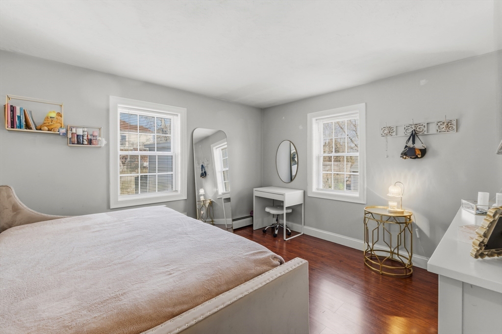 58 Bowler Street Fall River, MA 02723 - Photo 17 of 32 a bedroom with a bed a table and three windows