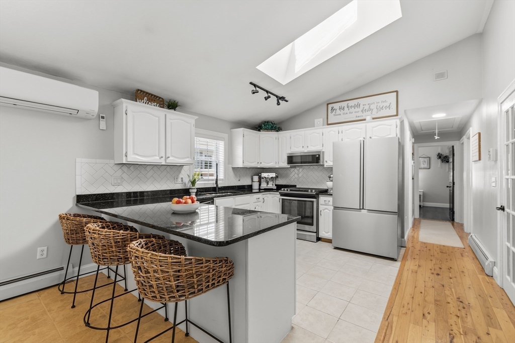 58 Bowler Street Fall River, MA 02723 - Photo 5 of 32 a kitchen with refrigerator and cabinets