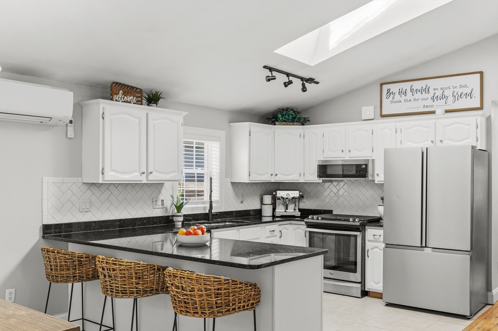 58 Bowler Street Fall River, MA 02723 - Photo 8 of 32 a kitchen with stainless steel appliances granite countertop a refrigerator sink and cabinets