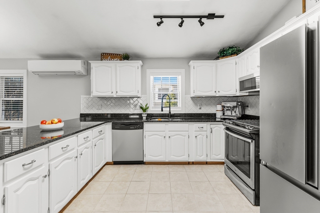 58 Bowler Street Fall River, MA 02723 - Photo 10 of 32 a kitchen with stainless steel appliances granite countertop a sink and cabinets