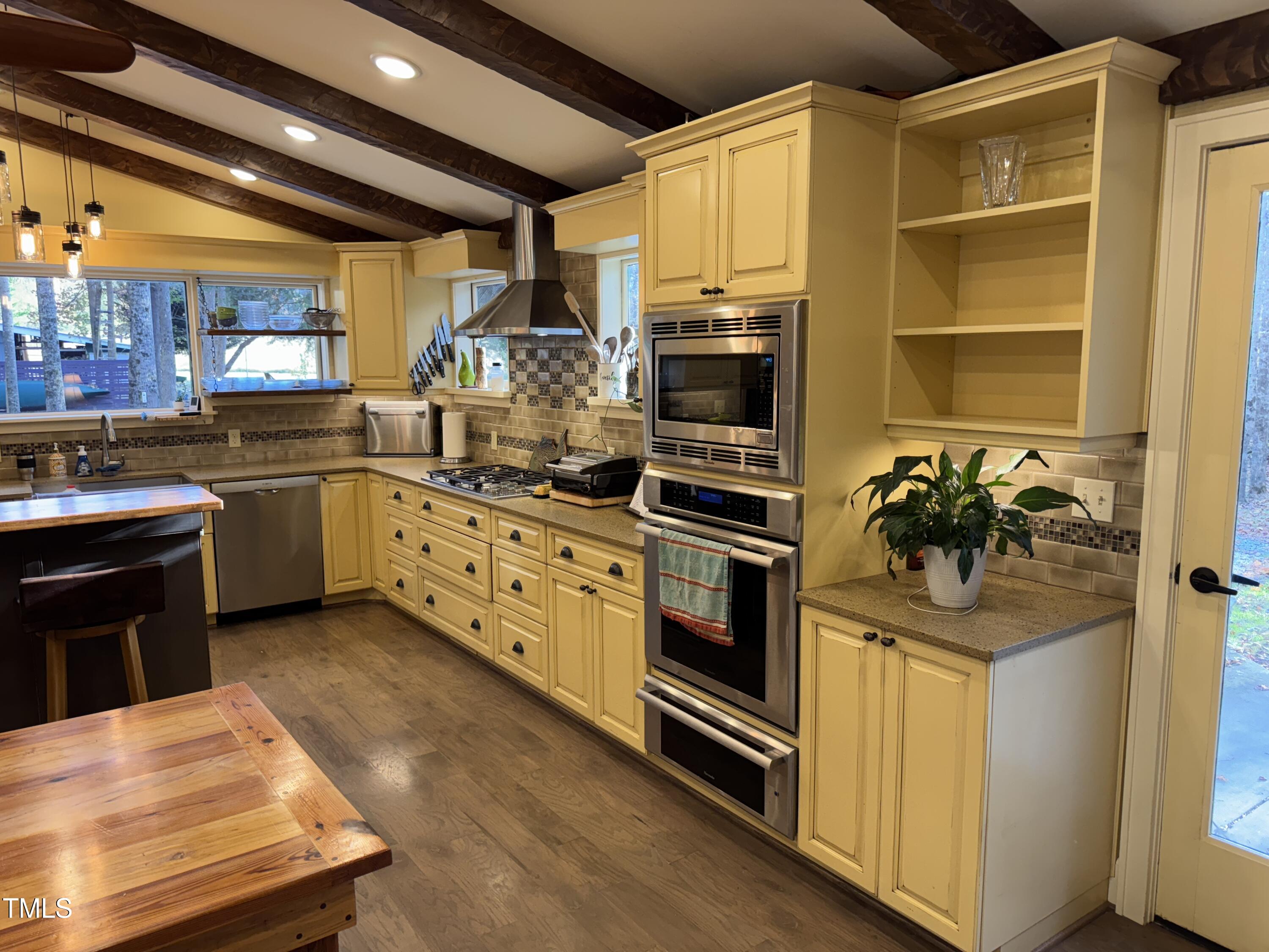 82 Woodspryte Hollow Road Timberlake, NC 27583 - Photo 17 of 29 a kitchen with stainless steel appliances a stove sink and microwave