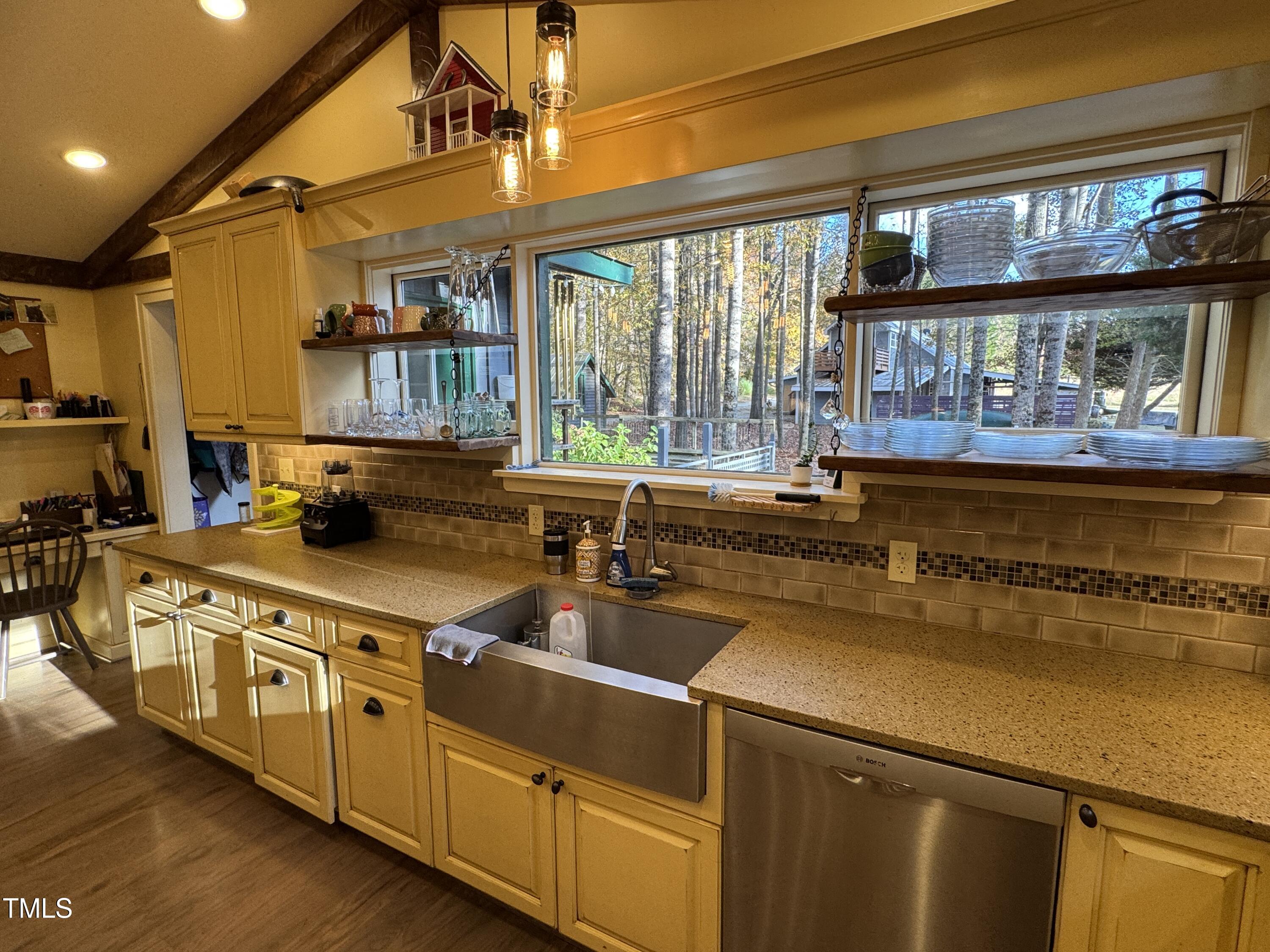 82 Woodspryte Hollow Road Timberlake, NC 27583 - Photo 19 of 29 a kitchen with stainless steel appliances granite countertop a stove and a sink