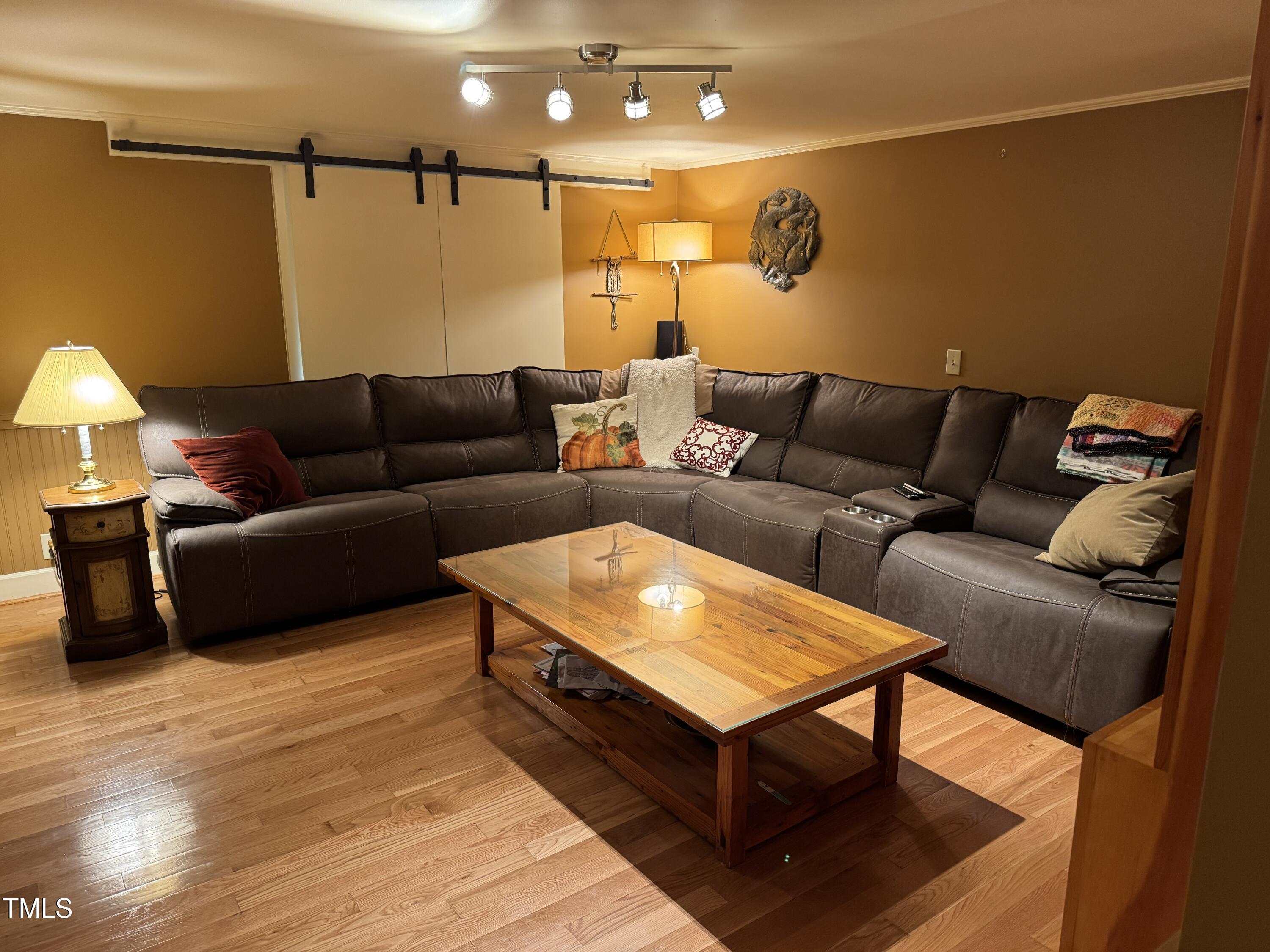 82 Woodspryte Hollow Road Timberlake, NC 27583 - Photo 22 of 29 a living room with furniture and a wooden floor