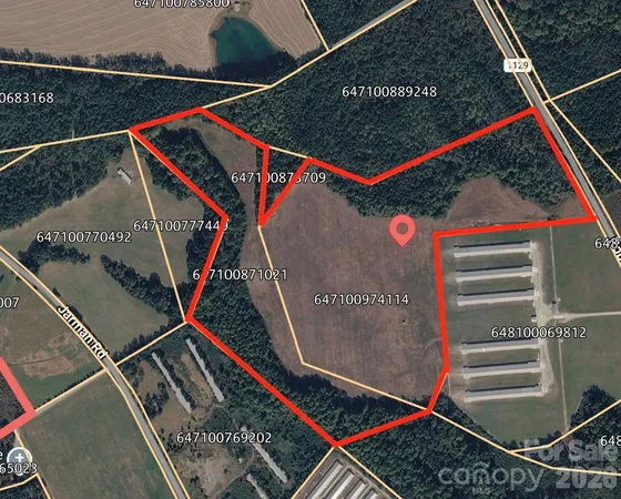 a view of a field with an trees in the background