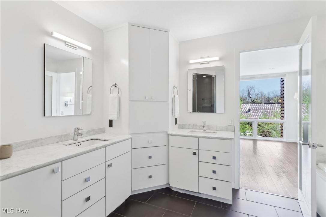 1852 Coltman Road Cleveland, OH 44106 - Photo 22 of 39 Primary Bathroom with tile patterned flooring, a sink, and two vanities