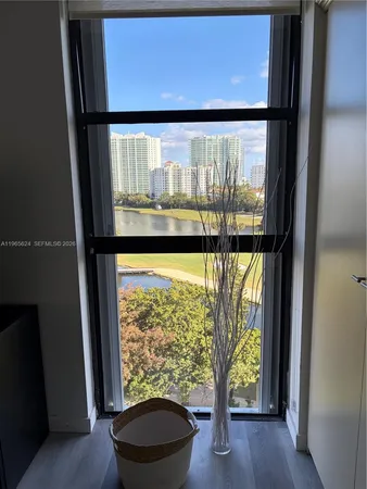 a view of a room with wooden floor and outdoor view