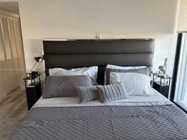 a bedroom with a bed and a night stand