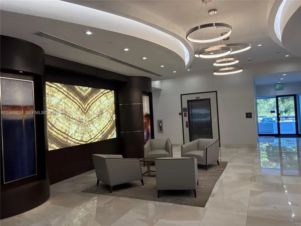 a living room with furniture and large windows