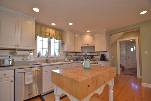251 Beverly Road Worcester, MA 01605 - Photo 2 of 22 a kitchen with a dining table chairs and white cabinets