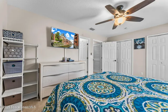 a living room with a bed and a flat screen tv