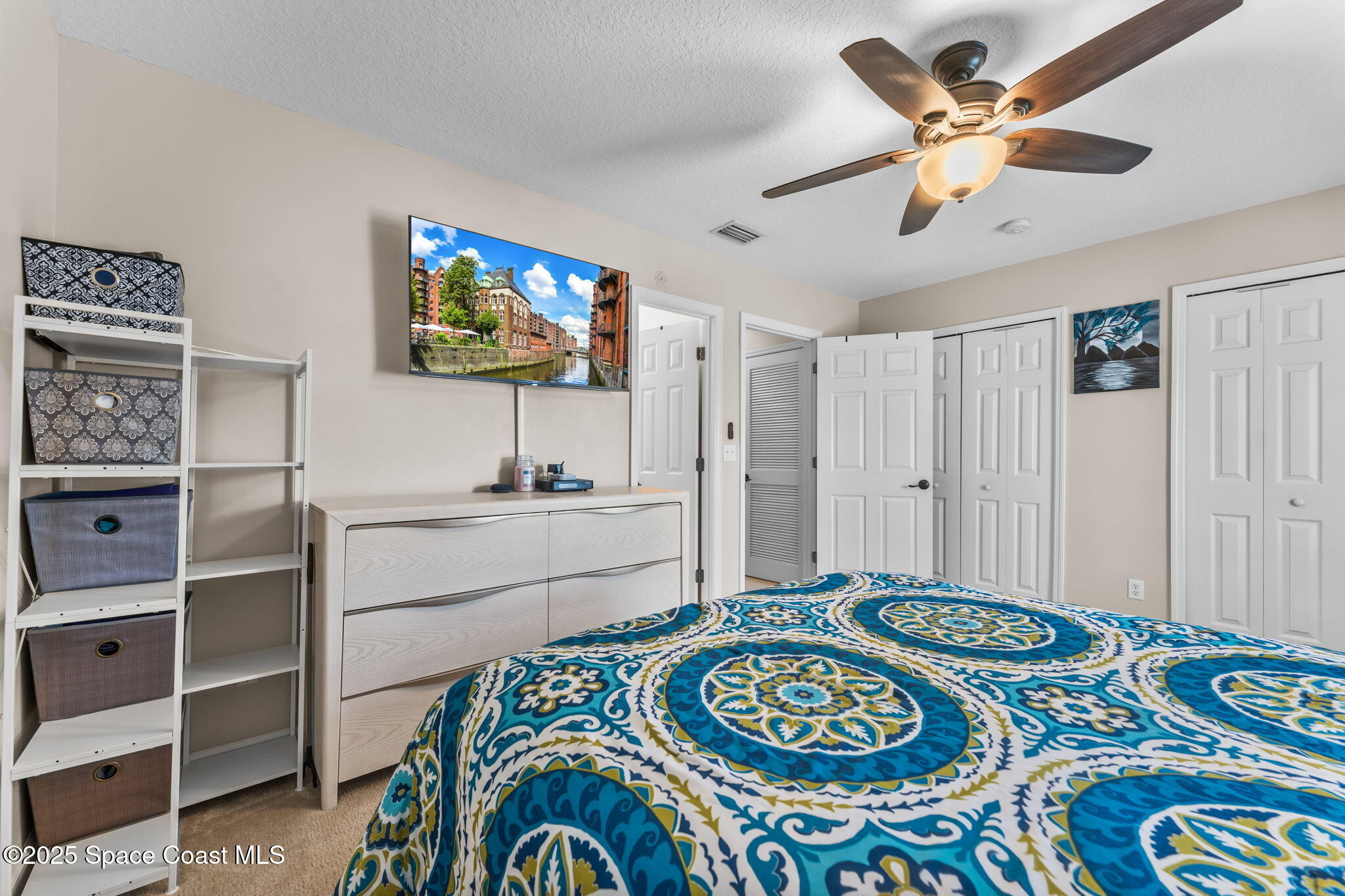 2690 Revolution Street, Unit 104 Melbourne, FL 32935 - Photo 17 of 35 a living room with a bed and a flat screen tv