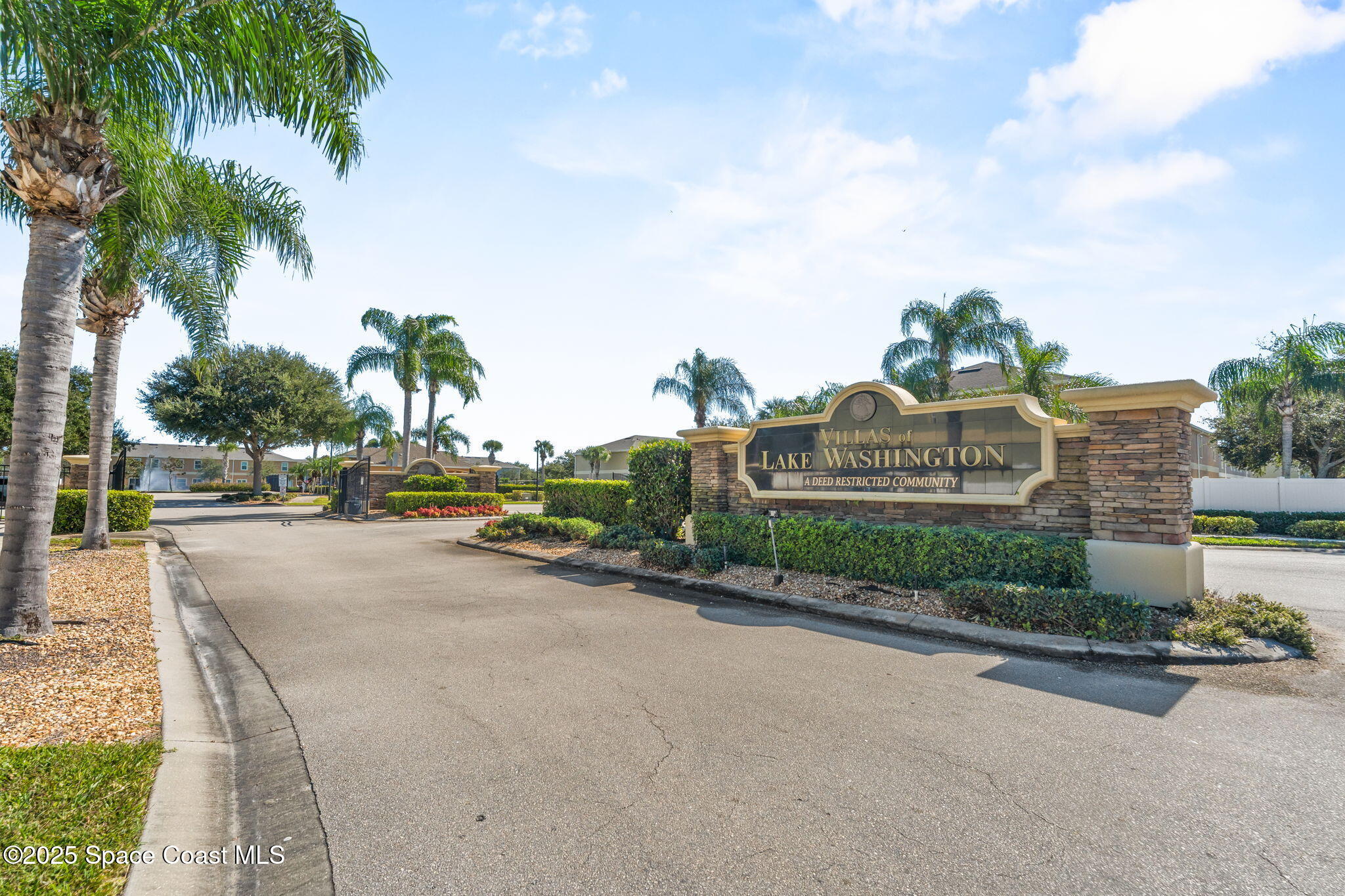 2690 Revolution Street, Unit 104 Melbourne, FL 32935 - Photo 32 of 35 a view of a street with a cars parked and small yard