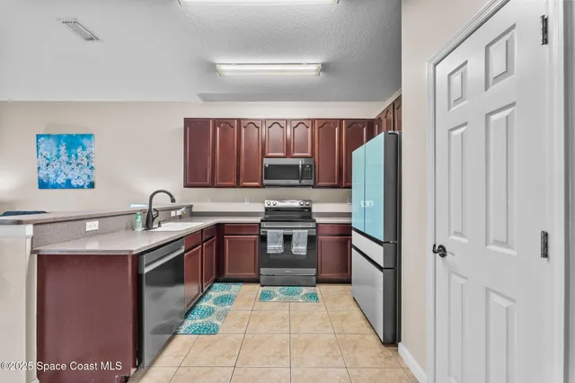 a kitchen with stainless steel appliances granite countertop a refrigerator stove and sink