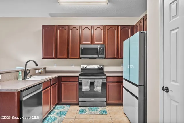 a kitchen with stainless steel appliances granite countertop a stove and a refrigerator