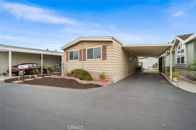 a large kitchen with cabinets a sink a dining table and chairs