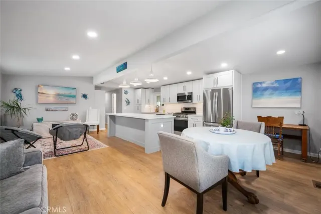 a living room with kitchen island furniture and a wooden floor