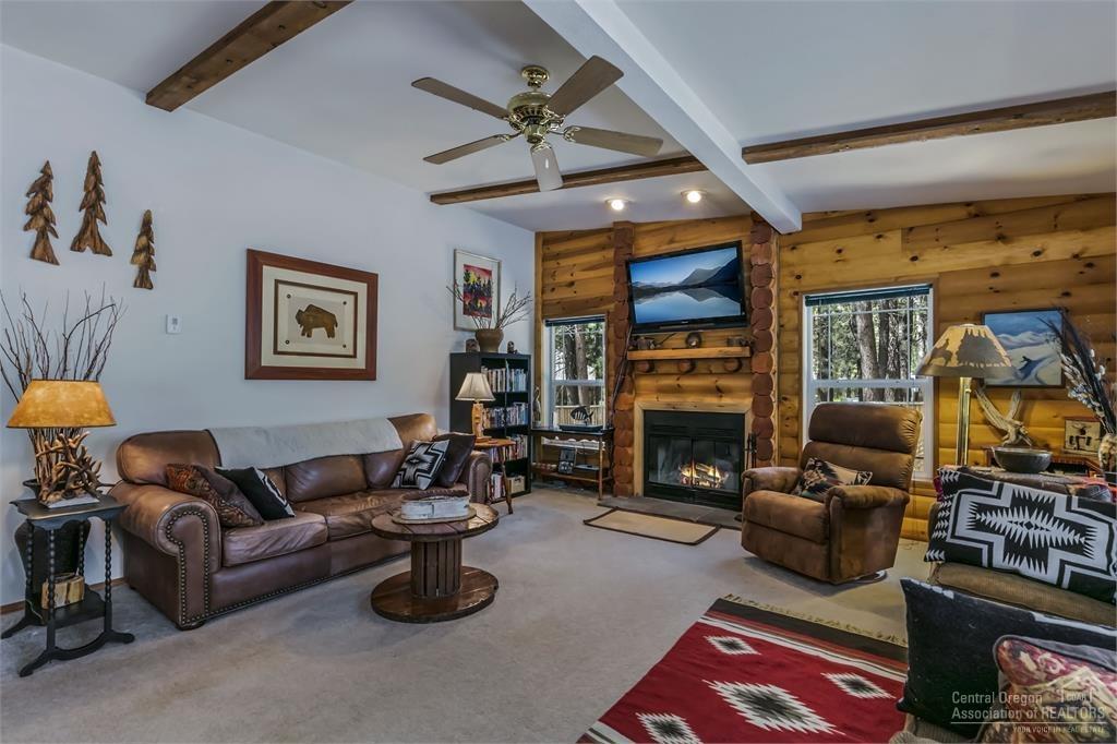 17171 Island Loop Way Bend, OR 97707 - Photo 15 of 25 a living room with furniture a flat screen tv and a fireplace