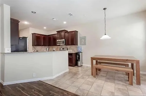 a kitchen with kitchen island a counter top space appliances and cabinets