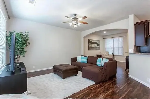 a living room with furniture and a chandelier