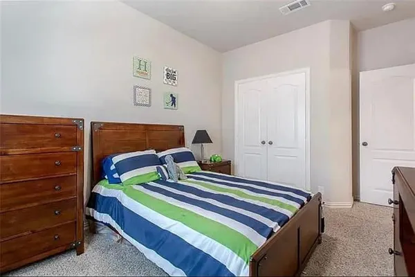 a bedroom with a bed and a closet