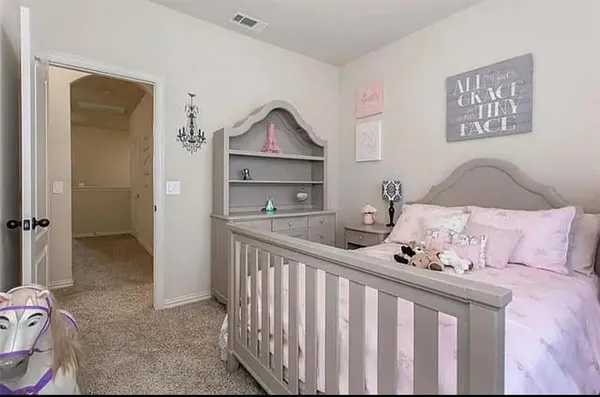 a bedroom with a bed and a chandelier